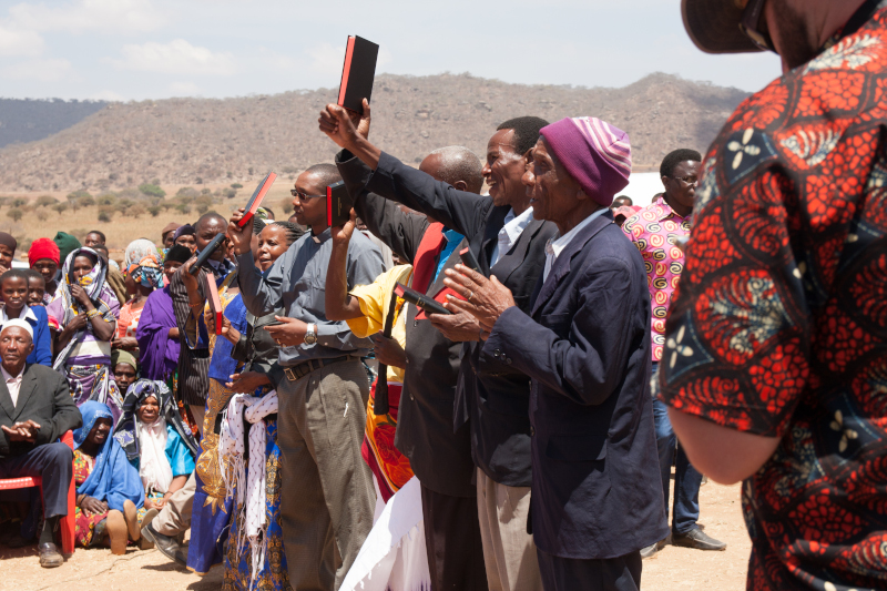 Tanzanian men celebrating their Bible.